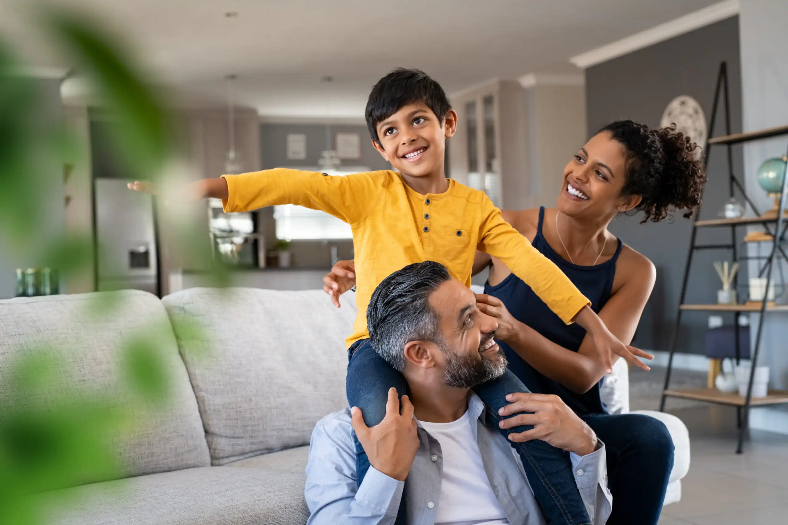 Happy son playing with ethnic parents